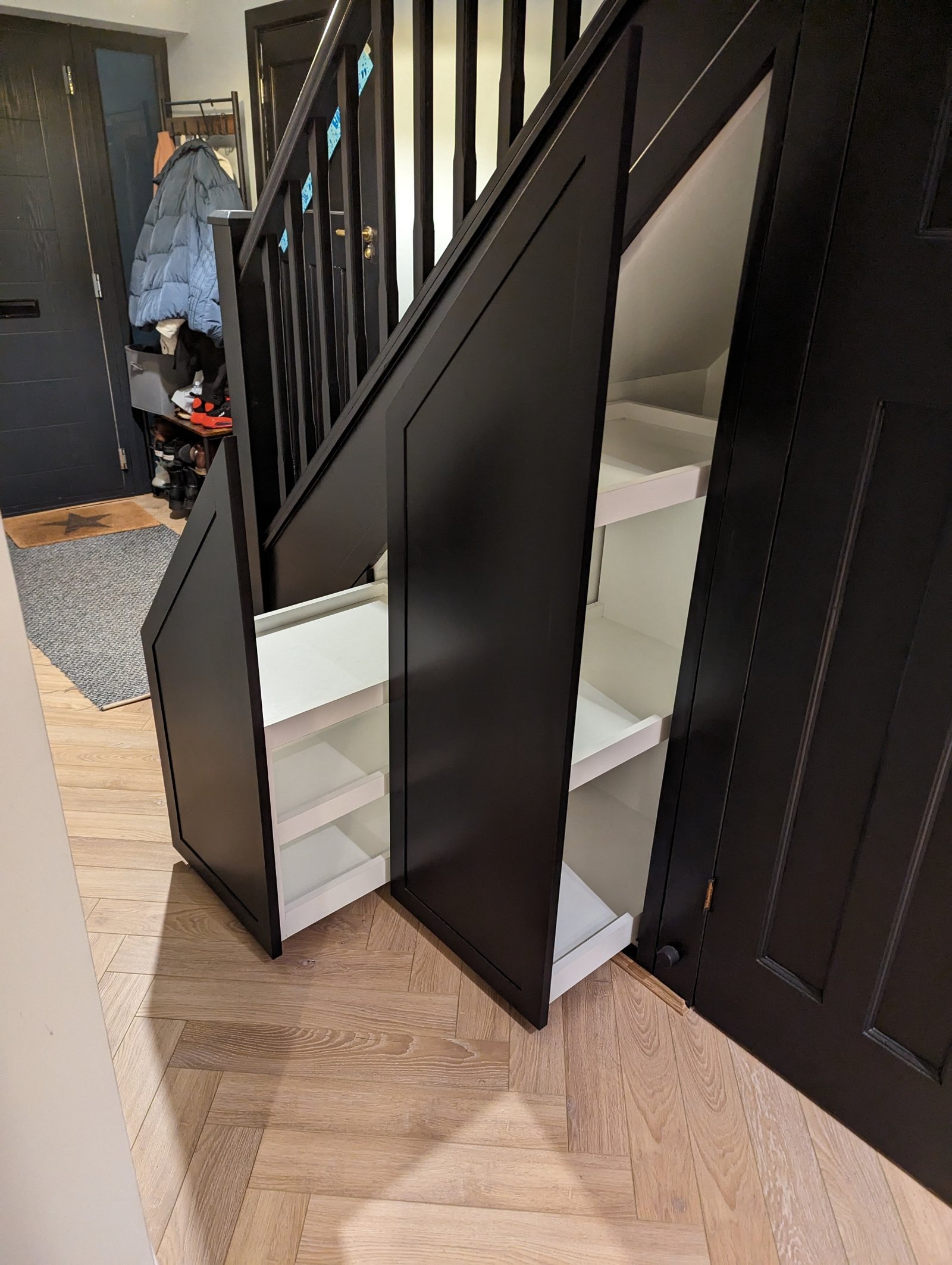 Craftsman installing bespoke fitted cabinetry in a luxury Birmingham home with custom joinery and interior woodwork.