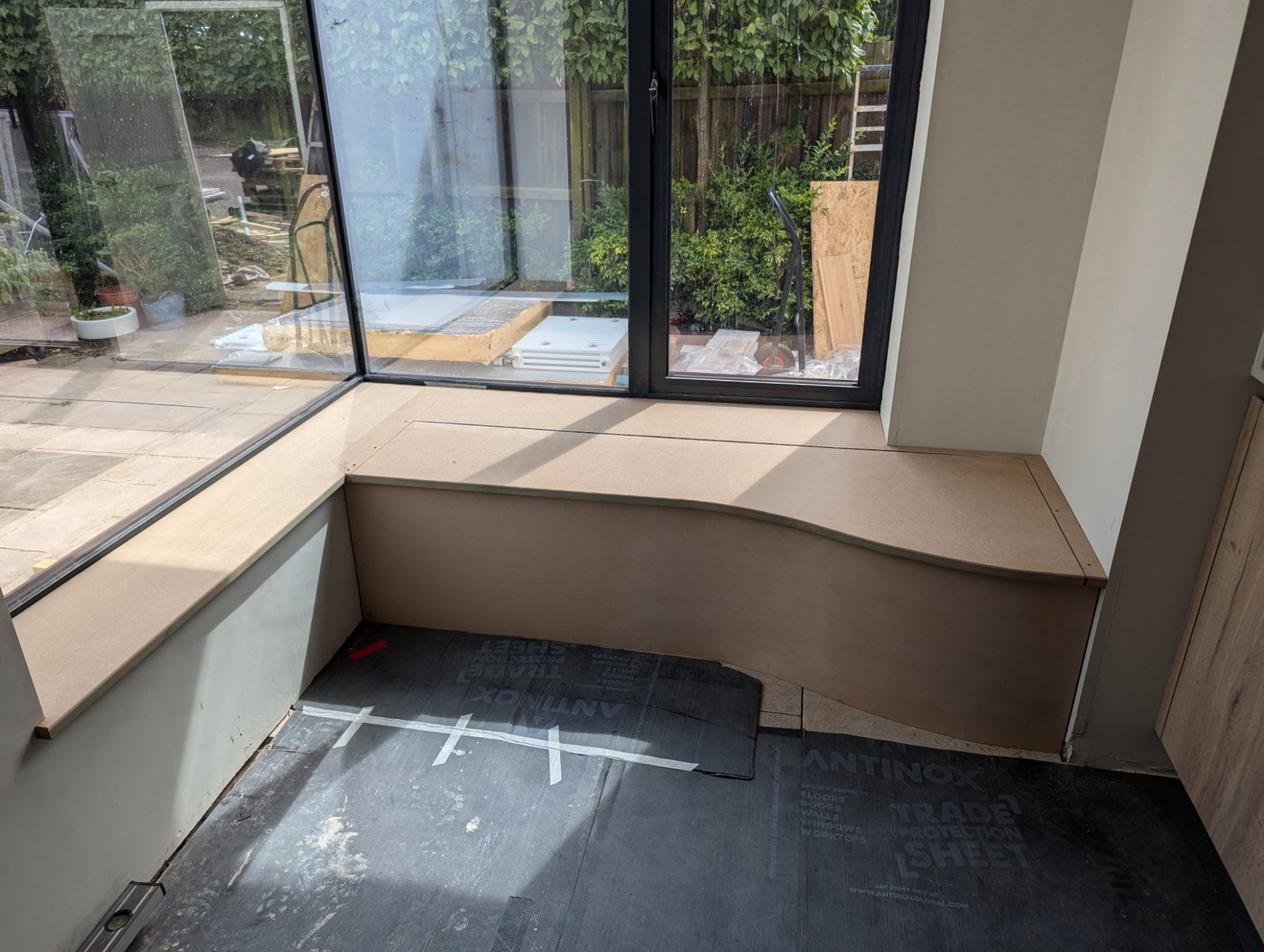 Craftsman installing bespoke fitted cabinetry in a luxury Birmingham home with custom joinery and interior woodwork.